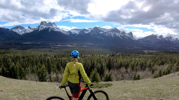 istock Female mountain biker rides e-bike along mountain ridge 1248834402