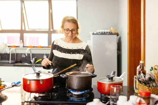 istock Woman cooking and preparing lunch at kitchen 1248835511