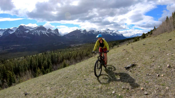 istock Female mountain biker rides e-bike along mountain ridge 1248835539