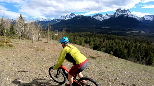 istock Female mountain biker rides e-bike along mountain ridge 1248835677