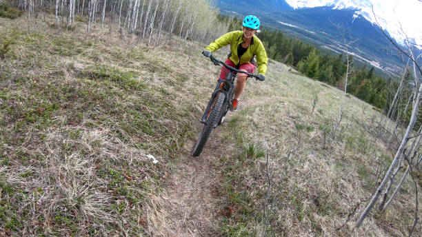 istock Female mountain biker rides e-bike along mountain ridge 1248837791