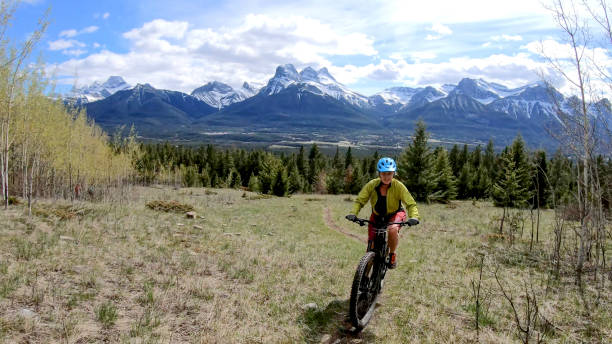 istock Female mountain biker rides e-bike along mountain ridge 1248839128