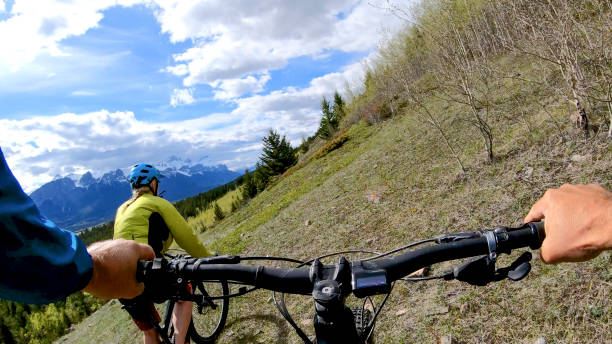 istock Female mountain biker rides e-bike along mountain ridge 1248841412