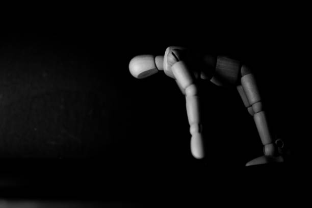 istock wooden mannequin back bending pose on black background 1248852754