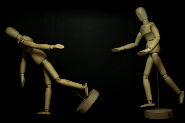 istock wooden mannequin chasing pose on black background 1248852907