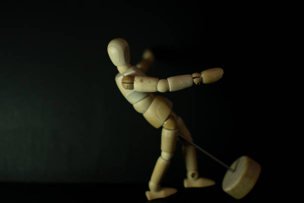 istock wooden mannequin falling down on black background 1248852910