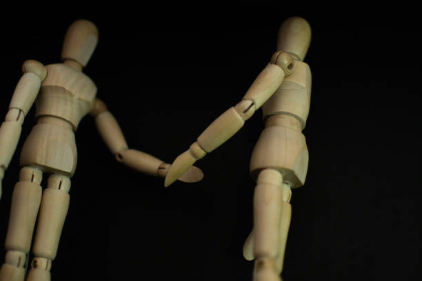 istock wooden mannequin holding a hand sign on background 1248854037