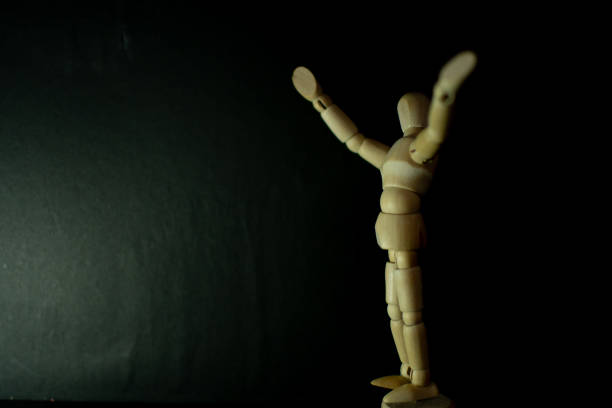 istock wooden mannequin lively fresh pose on black background 1248854063