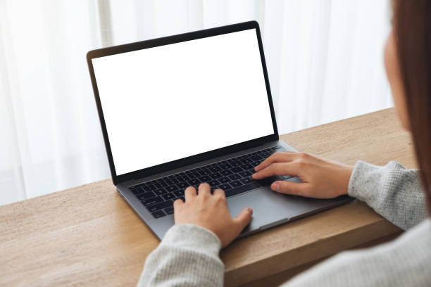 istock a woman using and typing on laptop computer with blank white desktop screen on wooden table 1248860350