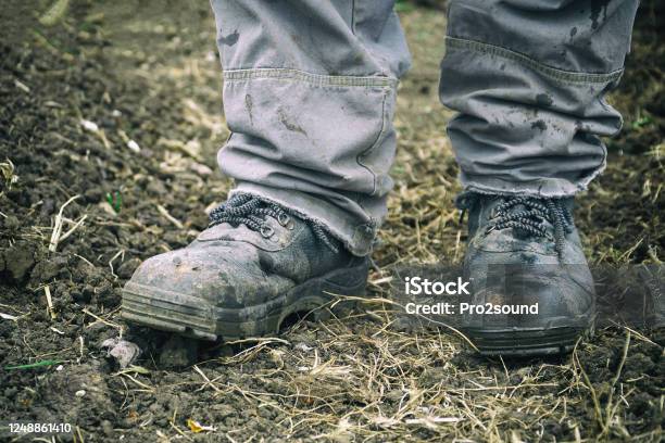Workers Feet In Dusty Boots Work Clothes Stock Photo - Download Image Now - Work Boot, Protective Workwear, Shoe