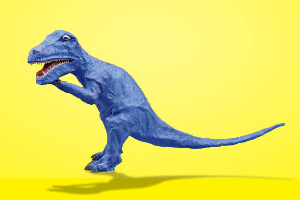 funny dinosaur isolated on yellow background with clipping path