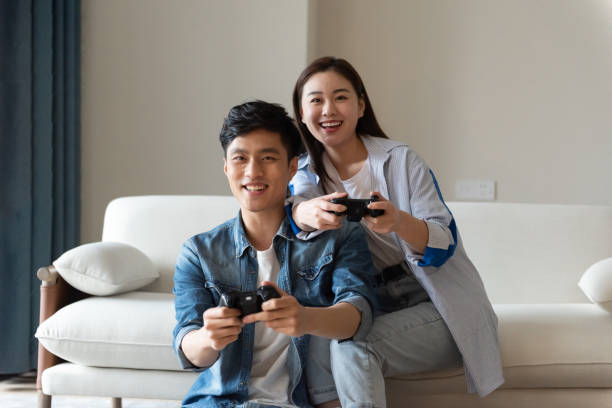 istock A young asian couple are playing games together 1248865923