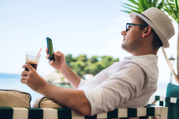 istock Checking social media in sea side cafe 1248866750
