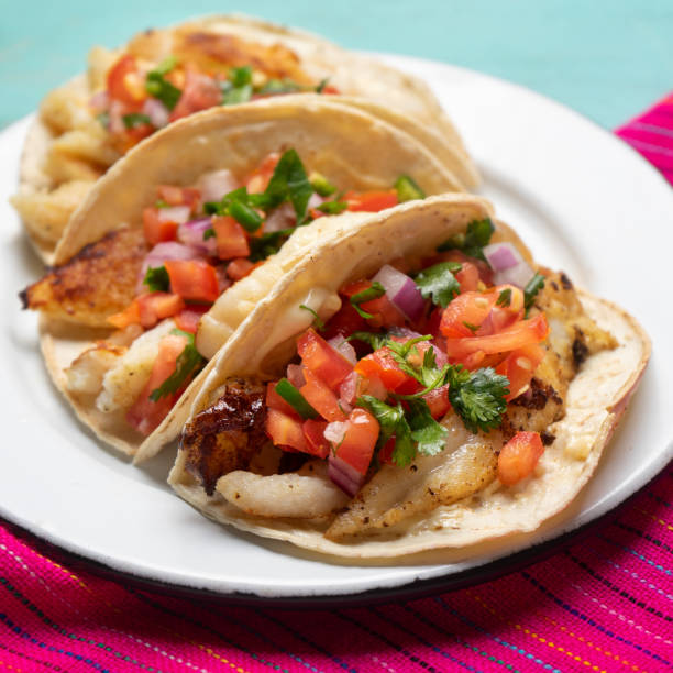 istock Mexican fish tacos also called Baja with fresh sauce on turquoise background 1248869317