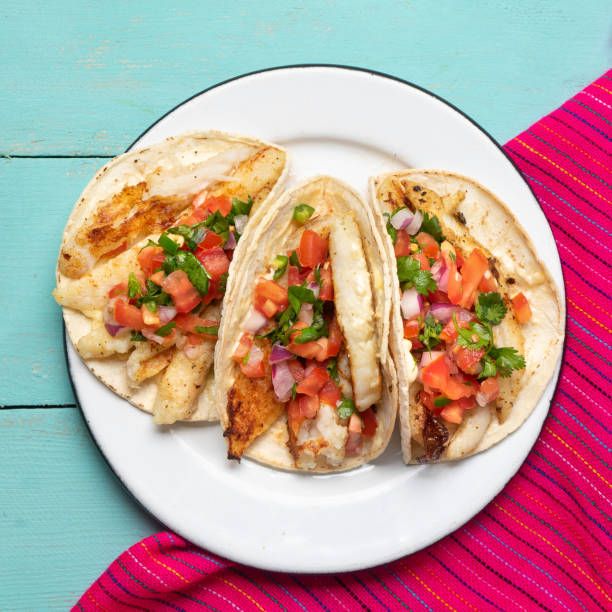 istock Mexican fish tacos also called Baja with fresh sauce on turquoise background 1248870013