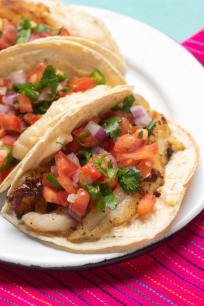 istock Mexican fish tacos also called Baja with fresh sauce on turquoise background 1248870114