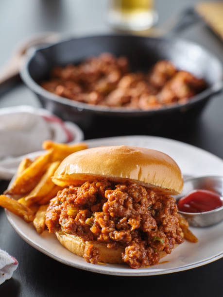 sloppy joe sandwich on plate with french fries and ketchup sloppy joe sandwich on plate with french fries and ketchup close up sloppy joes stock pictures, royalty-free photos & images