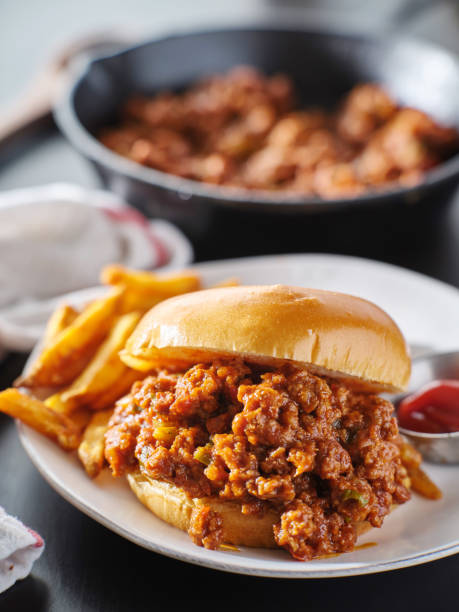 sloppy joe sandwich on plate with french fries and ketchup sloppy Joe sandwich on plate with french fries and ketchup close up sloppy joes stock pictures, royalty-free photos & images