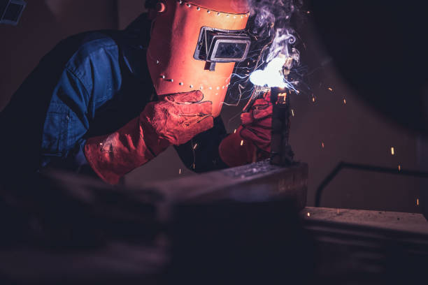 istock Metal welding steel works using electric arc welding machine 1248870396