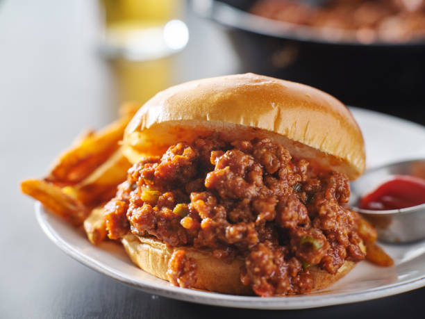 sloppy joe sandwich on plate with french fries and ketchup sloppy joe sandwich on plate with french fries and ketchup close up sloppy joes stock pictures, royalty-free photos & images