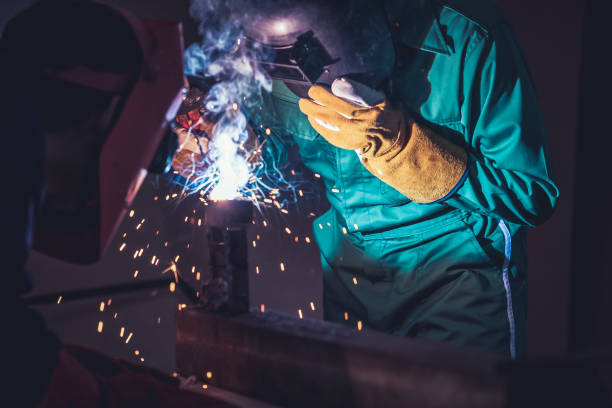 istock Metal welding steel works using electric arc welding machine 1248870416