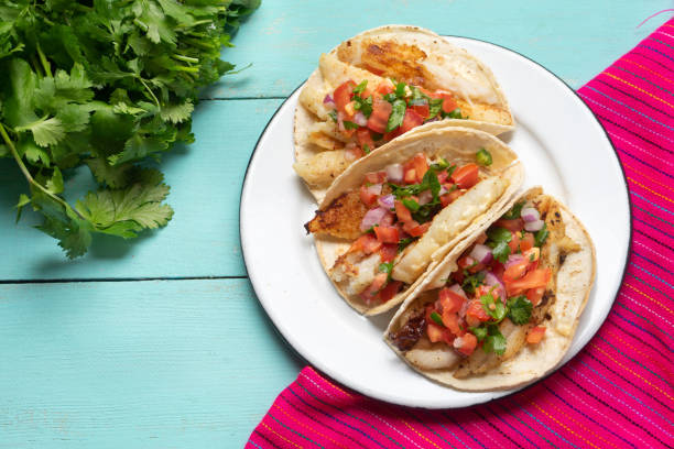 istock Mexican fish tacos also called Baja with fresh sauce on turquoise background 1248870434