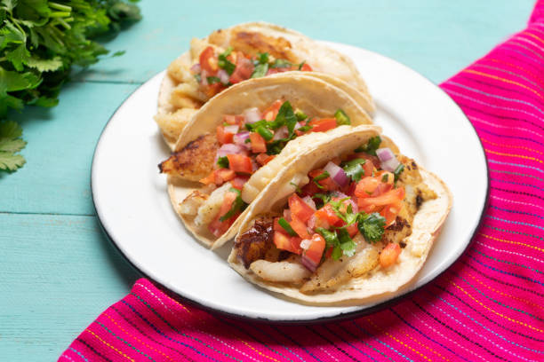 istock Mexican fish tacos also called Baja with fresh sauce on turquoise background 1248870582