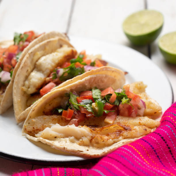 istock Mexican fish tacos also called Baja with fresh sauce on white background 1248871378