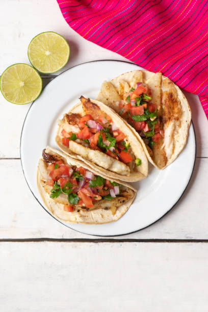 istock Mexican fish tacos also called Baja with fresh sauce on white background 1248871487