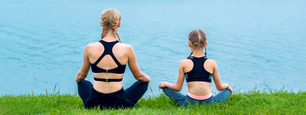 istock Mother and daughter doing yoga exercises 1248871746