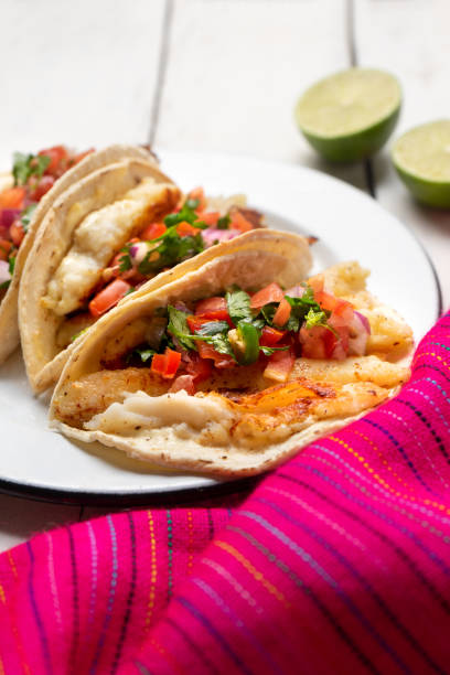 istock Mexican fish tacos also called Baja with fresh sauce on white background 1248871779