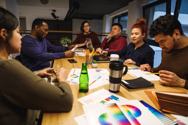 istock High angle view of team meeting aroung a crowded table 1248873629