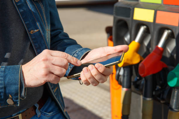 Refueling a car and paying using smartphone. stock photo