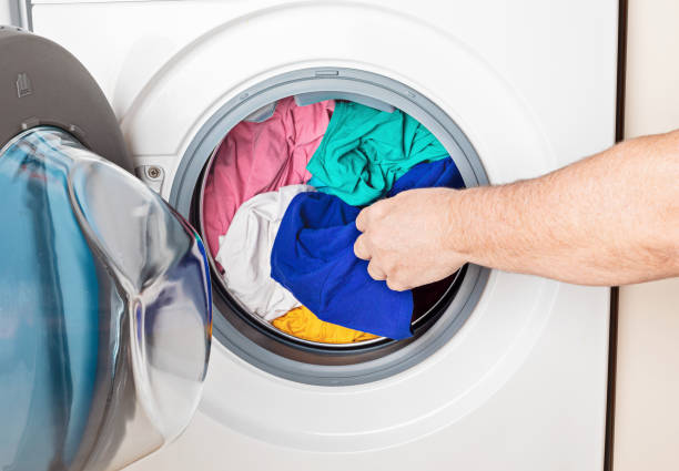 istock Washing or drying machine loaded with the laundry. Washing, spring cleaning idea 1248873739