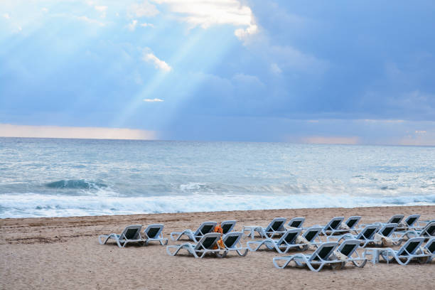 Empty beach and empty sunbeds on the beach of Turkey after Coronavirus outbreak, Beach and dramatic sky