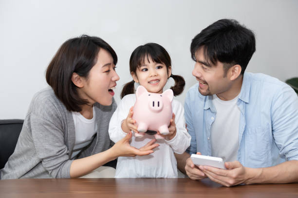 istock Young Asian mom and dad are saving money with daughter 1248875324