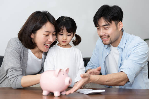 istock Young Asian mom and dad are saving money with daughter 1248875337