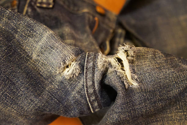 istock Close up tear in ripped denim jeans 1248877569