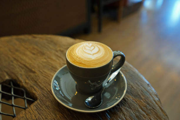 istock Close up ceramic cup of hot Latte coffee on wooden table 1248877656