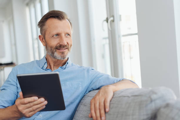 istock Thoughtful senior man looking aside as he relaxes 1248878951