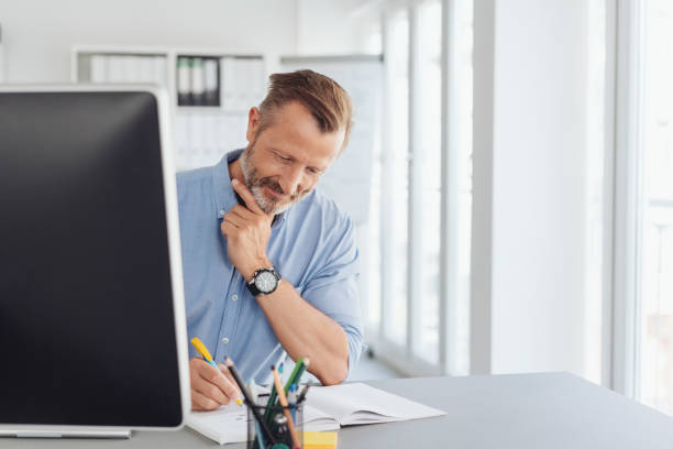 istock Thoughtful businessman writing notes in the office 1248879059