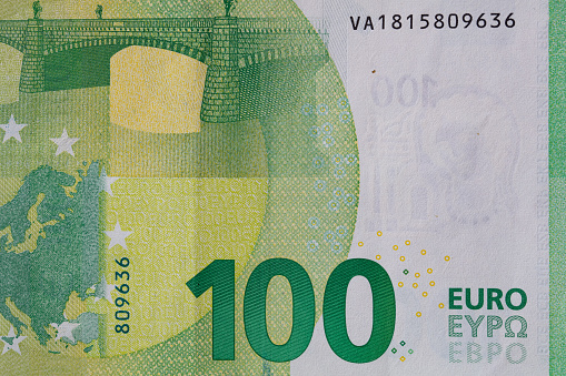 Close-up of the lower left edge of a Ten Euro note, on a black background.