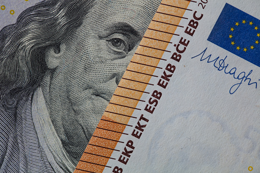Benjamin Franklin peeking through euro banknotes