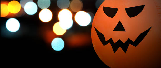 istock Pumpkin head doll on a black background with bokeh lights with copy space for, Halloween Concept 1248880702