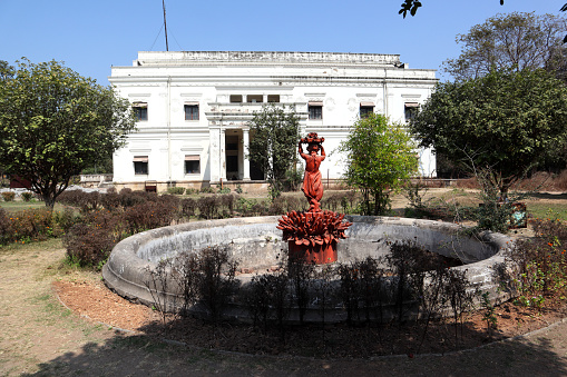Indore, Madhya Pradesh, India, February 11, 2020 : Fountain behind the Lal Bagh Palace, Indore, India. The Lal Bagh Palace was built by Maharaja Shivaji Rao Holkar in the year 1886-1921. The beautiful Palace is situated in the outskirts of the Indore city. It is a three storey building standing tall on the banks of the River Khan. The Lal Bagh Palace architecturally resembles the New Palace. The Palace also houses a coin collection which is from the Muslim period.