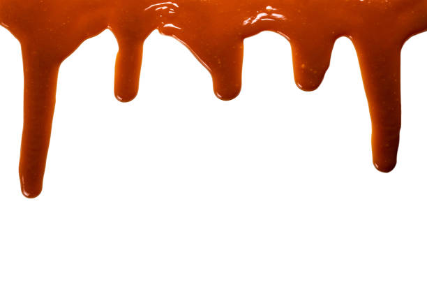 istock Background of flowing caramel sauce isolated on white. 1248883700