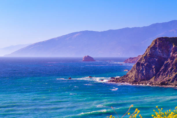 Stunning Big Sur California jeweled coastline with mountain cliffs into brilliant blue ocean