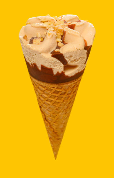 istock angle view milk tea flavor ice cream cone on a yellow background 1248885975