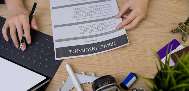 istock Travel preparation : searching information for travel insurance on mock-up tablet 1248887266