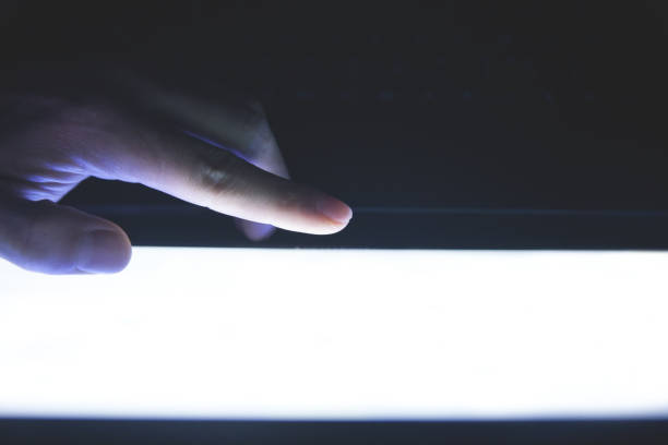 istock Male hand touching in screen at night. 1248887537